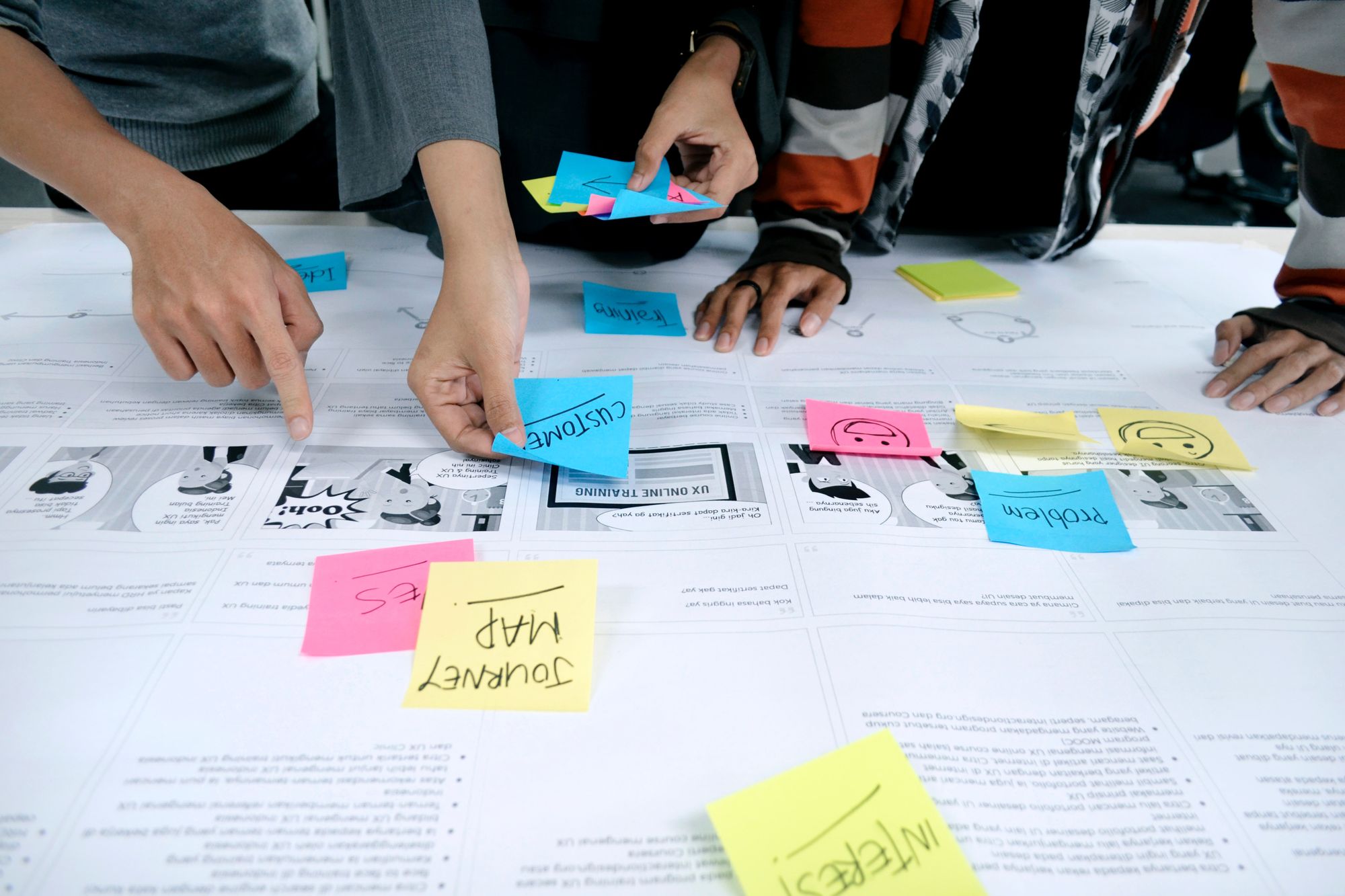 UX Designer using sticky notes for UX research